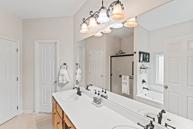 bathroom with tile patterned flooring, a washtub, and vanity