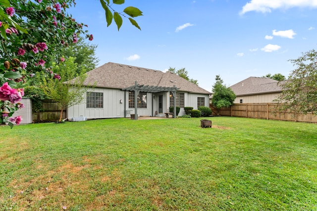 back of house featuring a pergola, a lawn, and a patio area