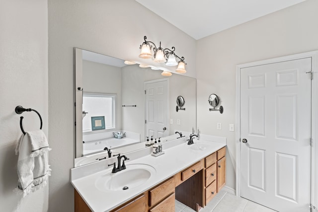 bathroom featuring vanity, a washtub, and tile patterned floors