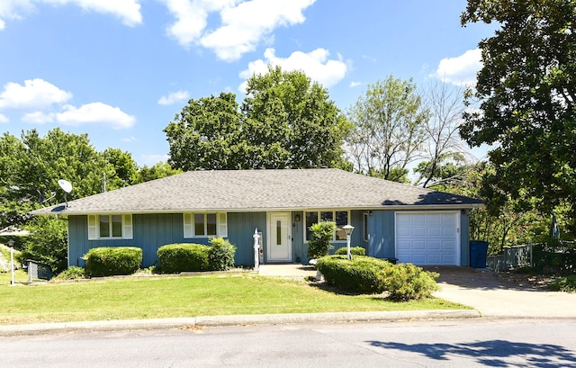 ranch-style home with a front lawn and a garage