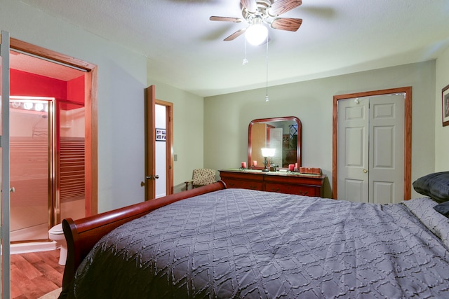 bedroom featuring hardwood / wood-style floors, ensuite bathroom, and ceiling fan