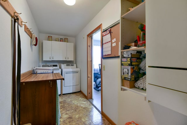 laundry room featuring washing machine and dryer and cabinets