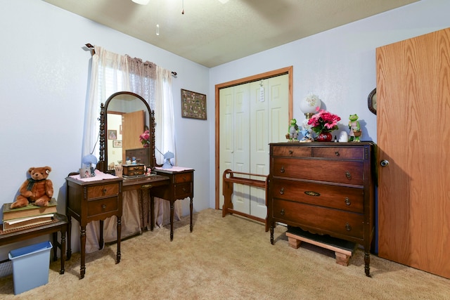 interior space featuring ceiling fan and light carpet