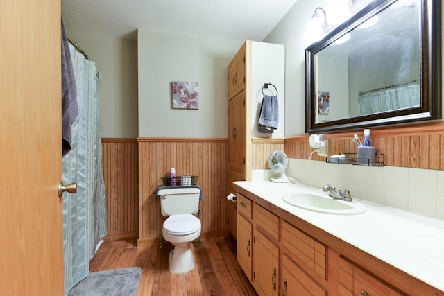 bathroom with vanity, hardwood / wood-style floors, and toilet