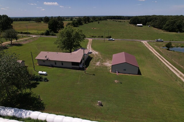 birds eye view of property featuring a rural view and a water view