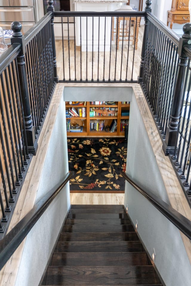 stairway with hardwood / wood-style flooring