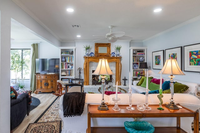 living room featuring ornamental molding, hardwood / wood-style flooring, and ceiling fan