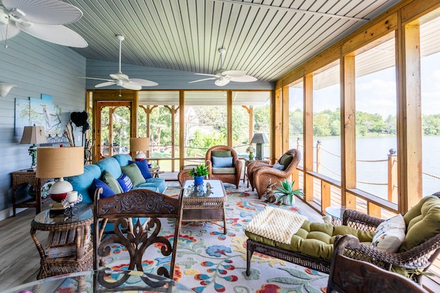 sunroom featuring a water view and wood ceiling