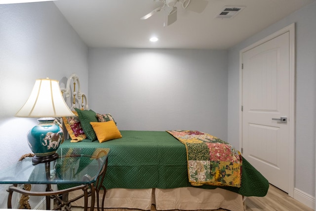 bedroom with ceiling fan and hardwood / wood-style floors