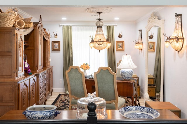 dining room with crown molding and a chandelier