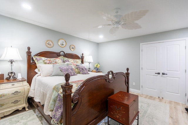 bedroom featuring ceiling fan, a closet, and wood-type flooring