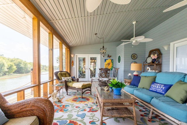 sunroom with ceiling fan, lofted ceiling, and french doors