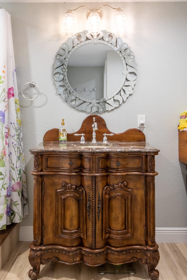 bathroom with hardwood / wood-style flooring and vanity