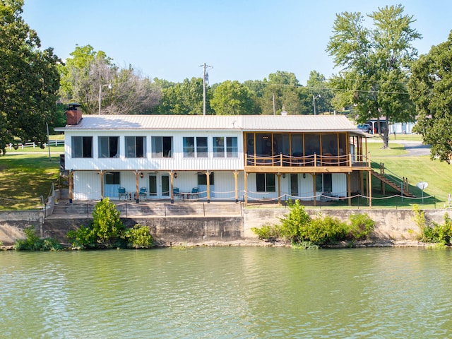 rear view of property with a patio and a water view