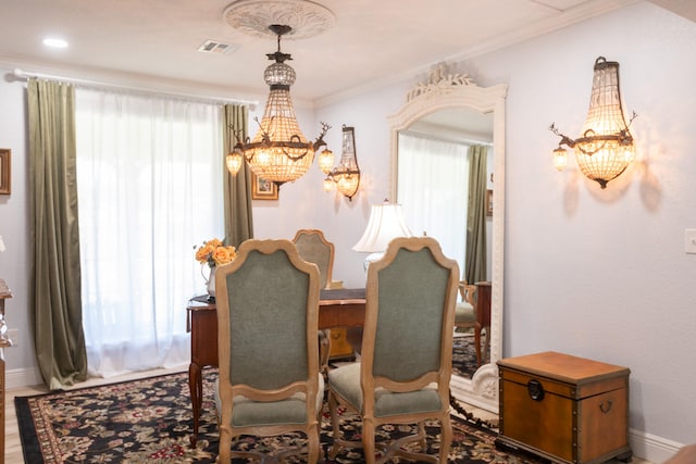 dining space featuring ornamental molding, a wealth of natural light, and a chandelier