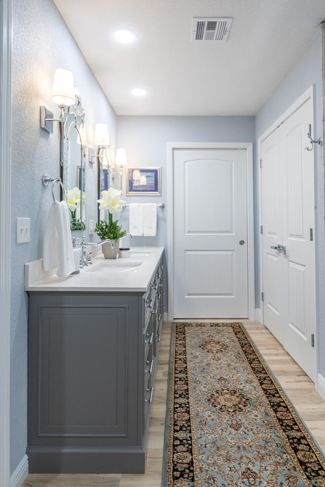 bathroom with wood-type flooring and vanity