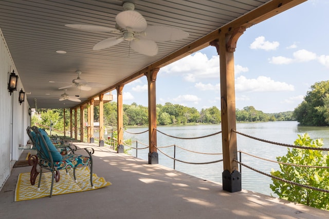 view of patio / terrace featuring ceiling fan and a water view