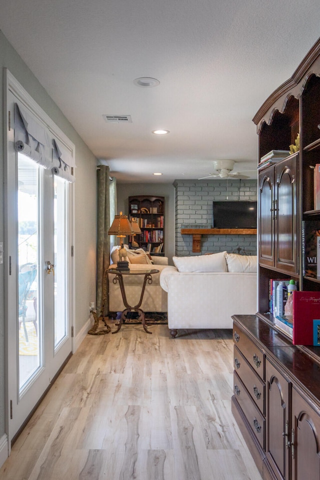 living room featuring light hardwood / wood-style floors and a wealth of natural light