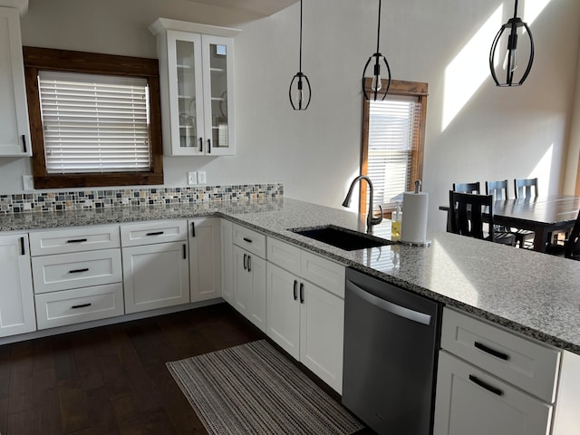 kitchen with pendant lighting, dark hardwood / wood-style flooring, sink, dishwasher, and white cabinetry