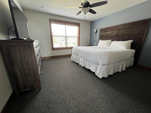 bedroom featuring dark carpet and ceiling fan