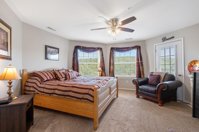 bedroom with carpet floors, multiple windows, and ceiling fan