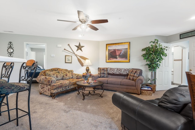 living room with ceiling fan and carpet