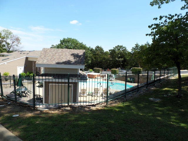 view of pool with a patio area and a lawn