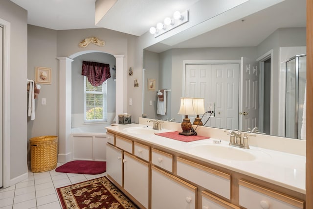 bathroom featuring plus walk in shower, tile patterned floors, decorative columns, and vanity