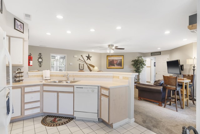 kitchen with ceiling fan, light colored carpet, sink, white dishwasher, and kitchen peninsula