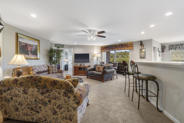 carpeted living room featuring ceiling fan