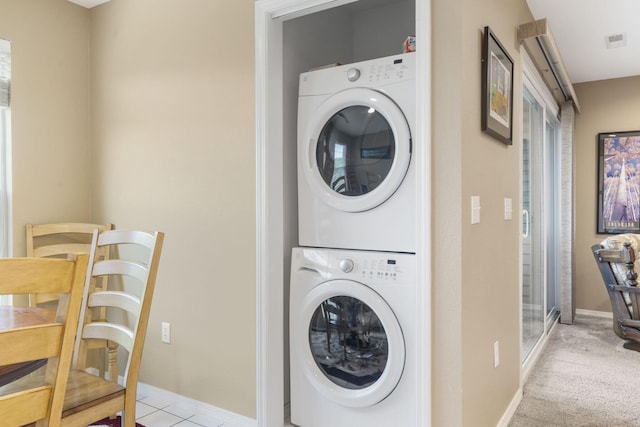 washroom with light carpet and stacked washing maching and dryer