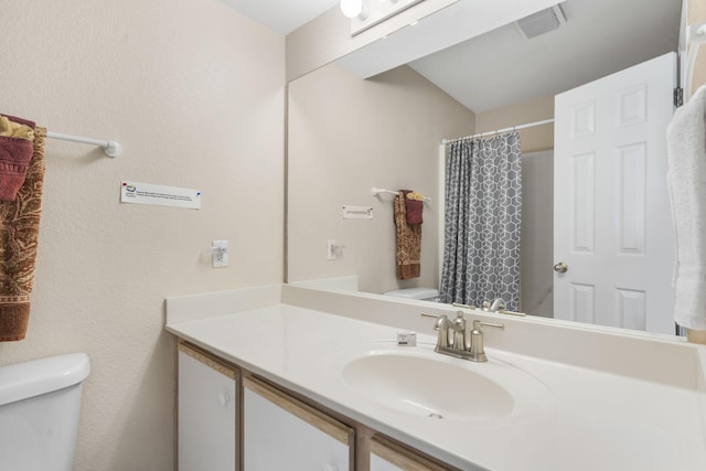 bathroom featuring vanity, toilet, and a shower with curtain