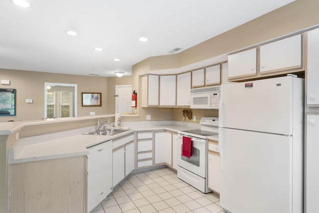 kitchen featuring white appliances, sink, and white cabinetry