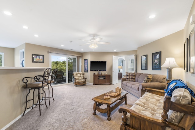 living room featuring light carpet and ceiling fan