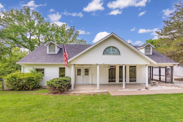 rear view of house with a patio and a yard