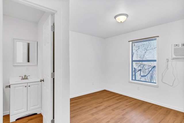 spare room featuring light hardwood / wood-style flooring and sink