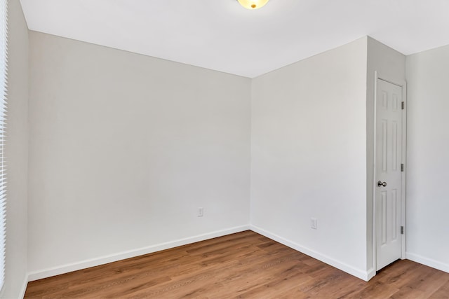 spare room featuring wood-type flooring