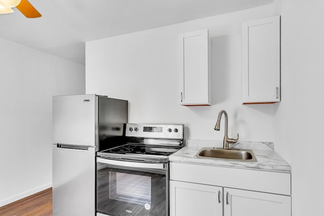 kitchen featuring white cabinets, hardwood / wood-style flooring, stainless steel appliances, and sink