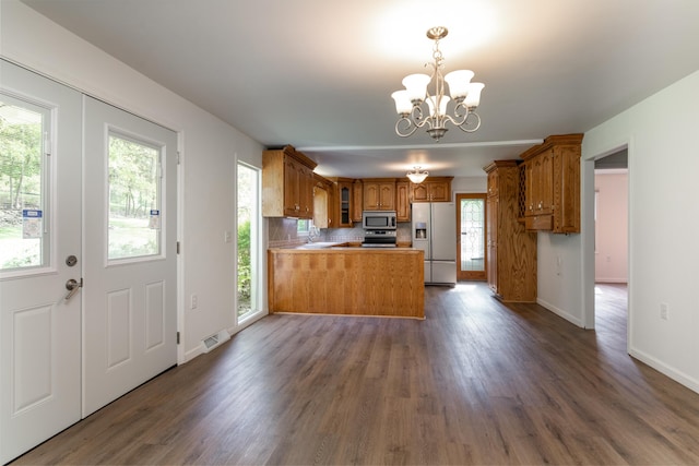kitchen with appliances with stainless steel finishes, plenty of natural light, and kitchen peninsula