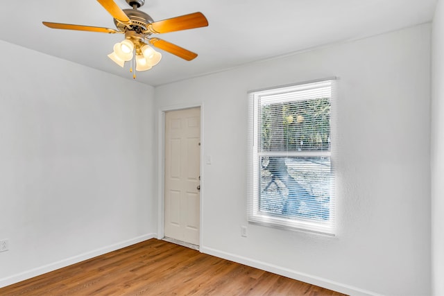 unfurnished room featuring ceiling fan, light wood-type flooring, and a healthy amount of sunlight