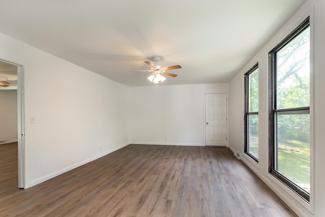 spare room with wood-type flooring and ceiling fan