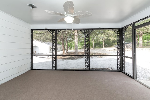 unfurnished sunroom with ceiling fan