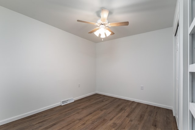 spare room featuring ceiling fan and dark hardwood / wood-style flooring