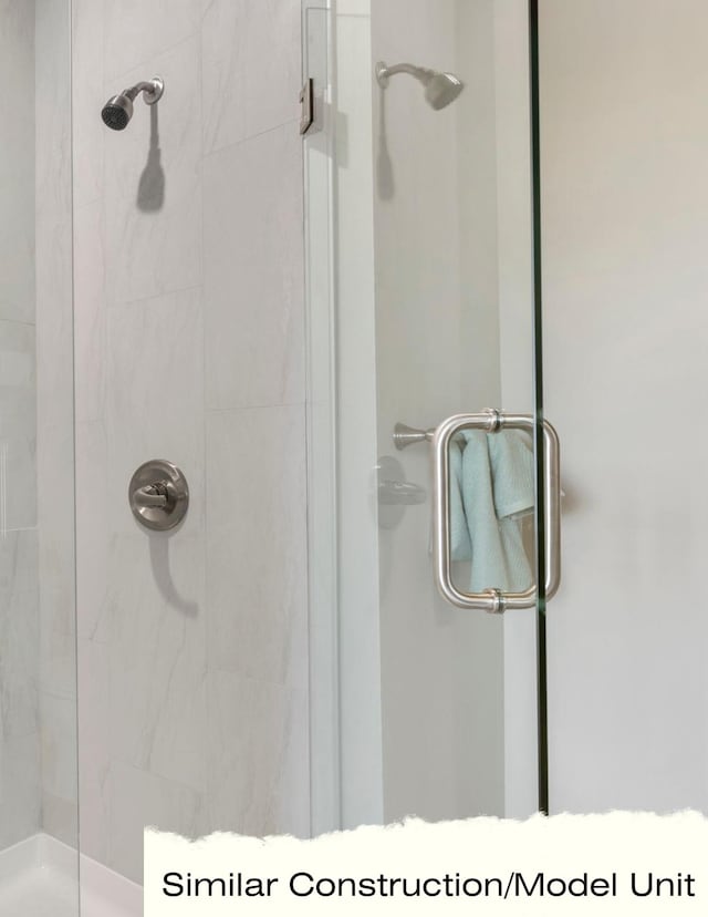 bathroom with a shower with shower door