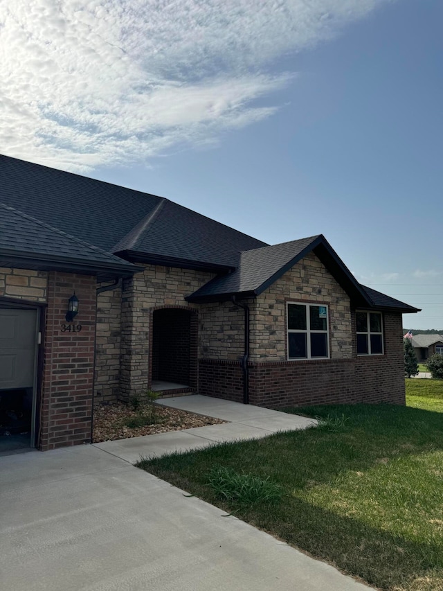 single story home featuring a front yard and a garage