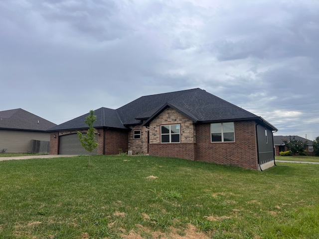 view of front of property featuring a garage and a front lawn