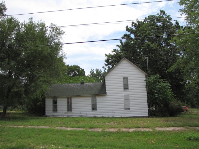 view of side of home featuring a yard