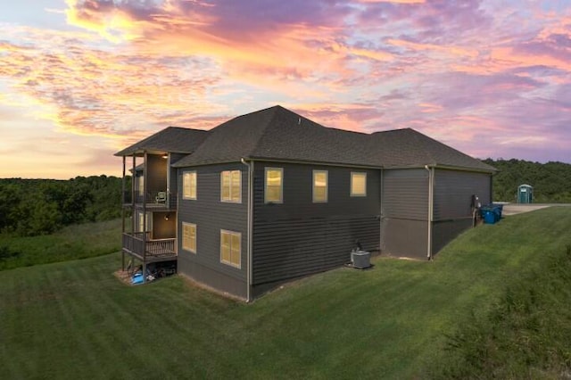 property exterior at dusk with a yard