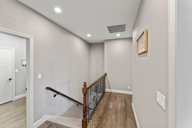 stairway featuring wood-type flooring