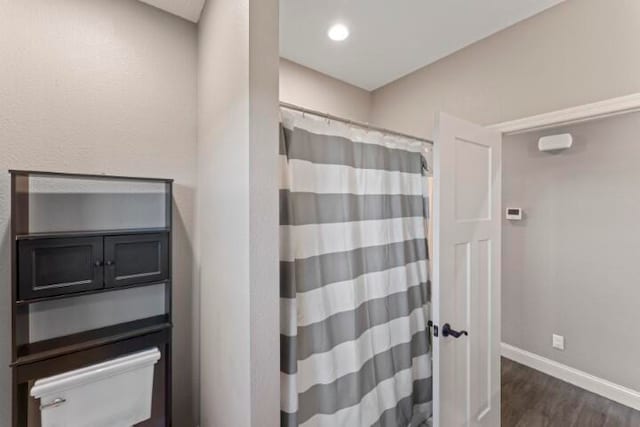 bathroom with a shower with curtain and hardwood / wood-style flooring